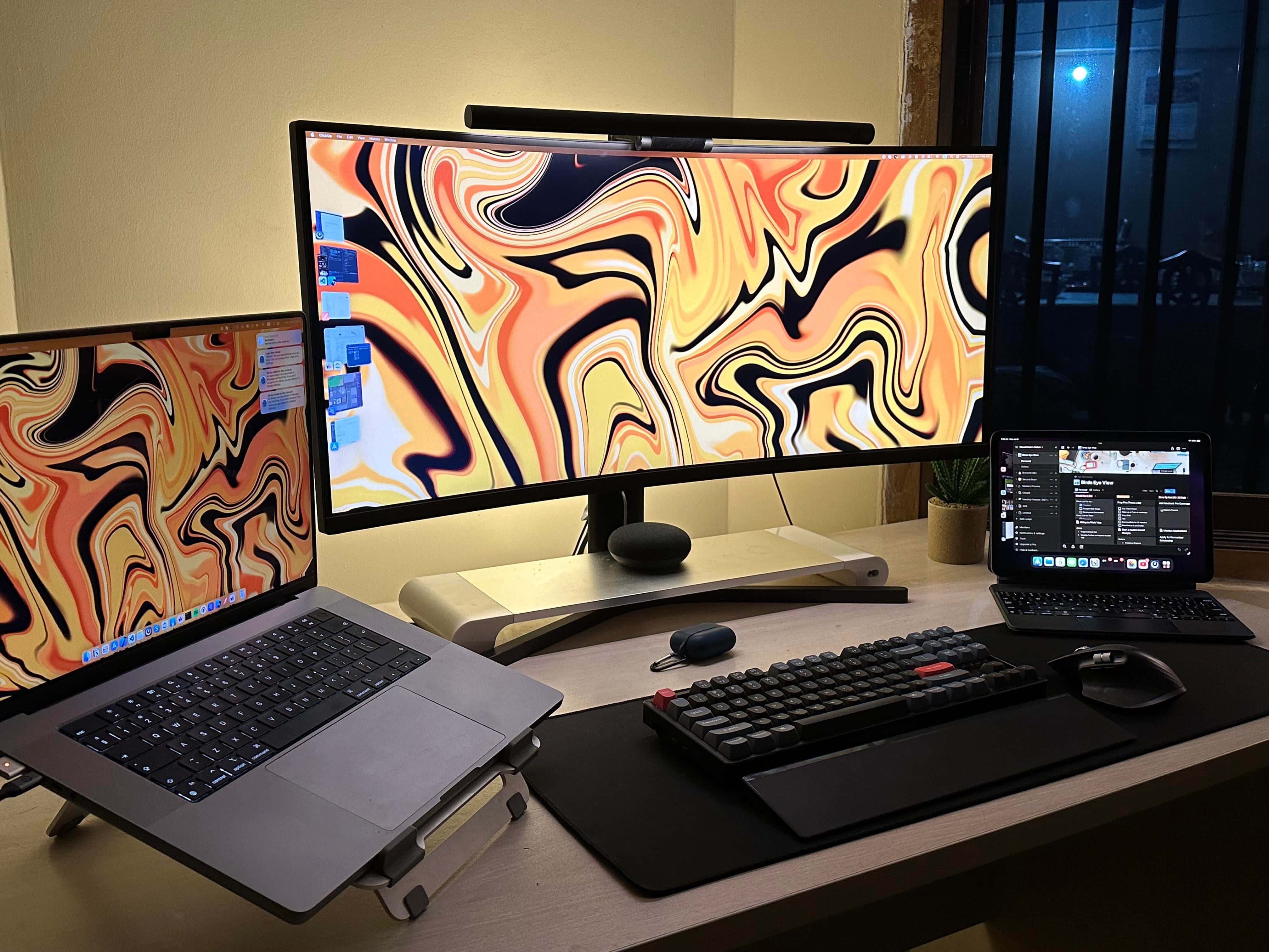 Text renders more clearly on the MacBook Pro's Liquid Retina display than on the ultra-wide monitor.