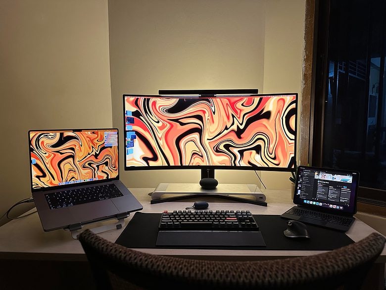 The bigger desk allows for three displays, not to mention three keyboards.