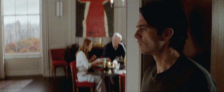 Sebastian Stan, Julianne Moore and John Lithgow in a scene from "Sharper," a new thriller film from Apple TV+.