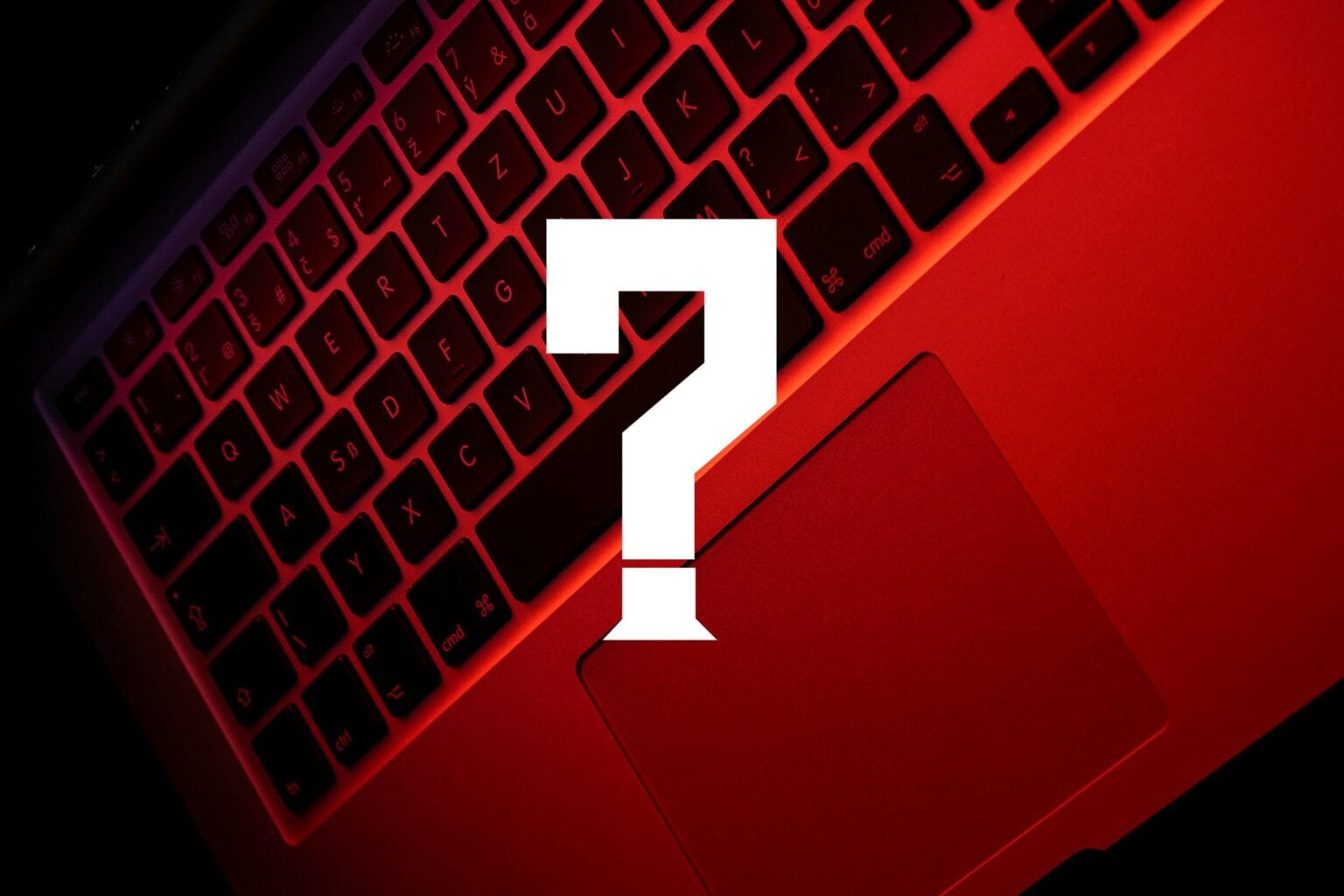 A MacBook Air with ominous red lighting and a giant white question mark.