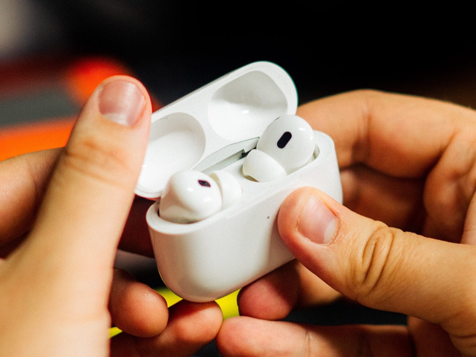 AirPods Pro 2 in hand with case opened