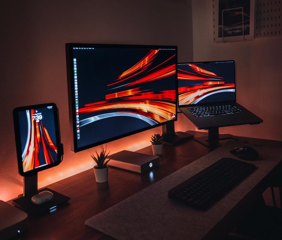 Mounted devices make for a space-saving triple-display setup.