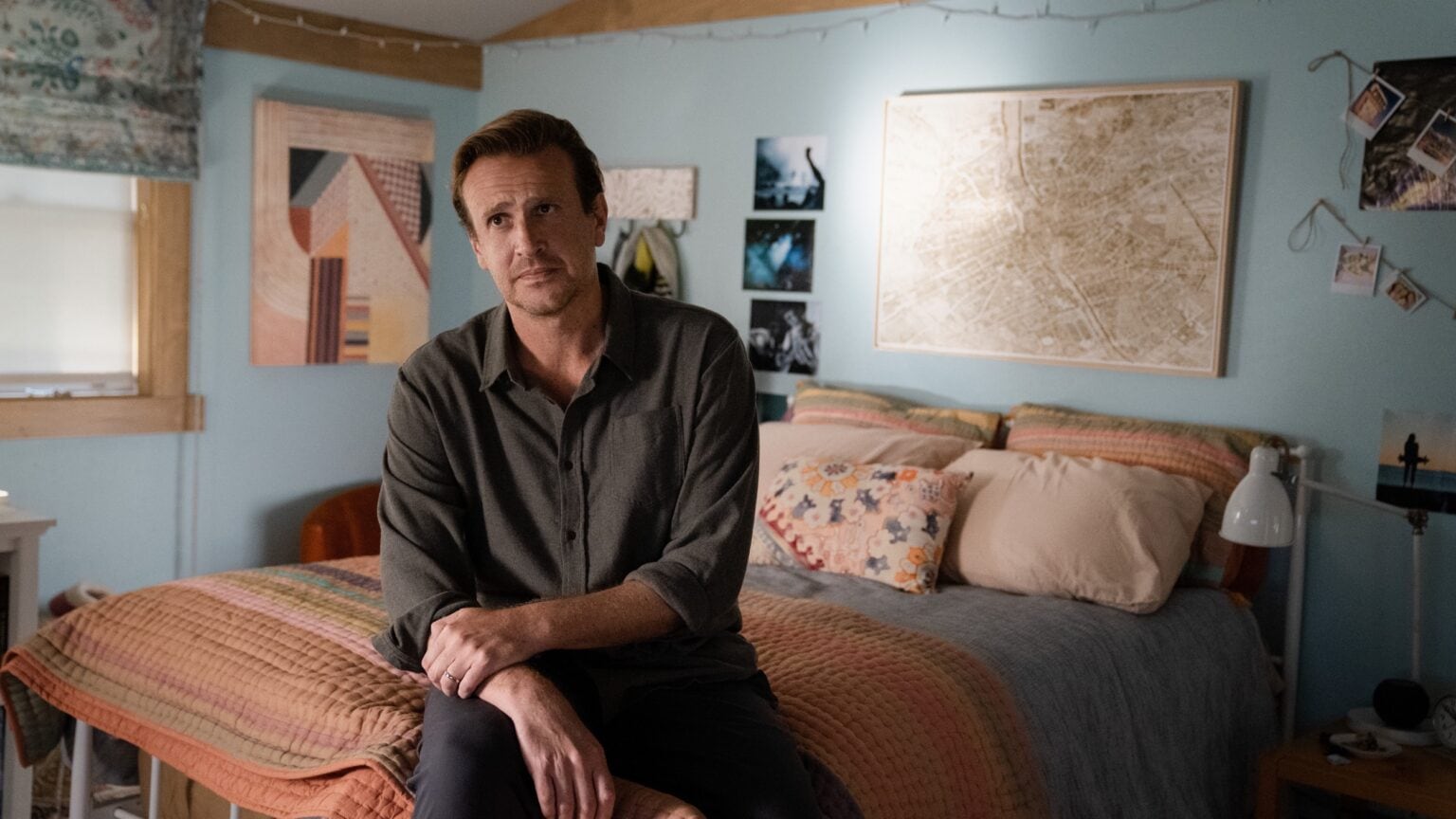 Jimmy, played by Jason Segel, sits on a bed in a scene from 