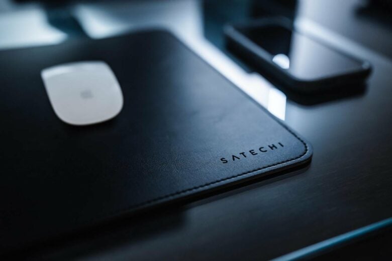 The leather Satechi desk mat rests on a large tempered-glass blotter. 