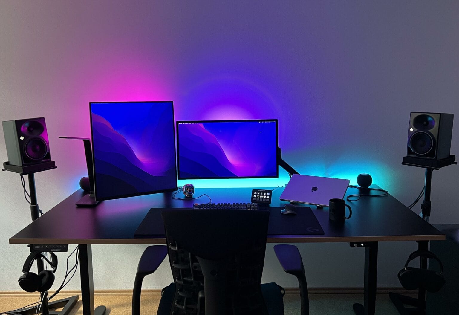 The user, a developer, finds a Studio Display paired with an LG DualUp monitor ideal for his work.