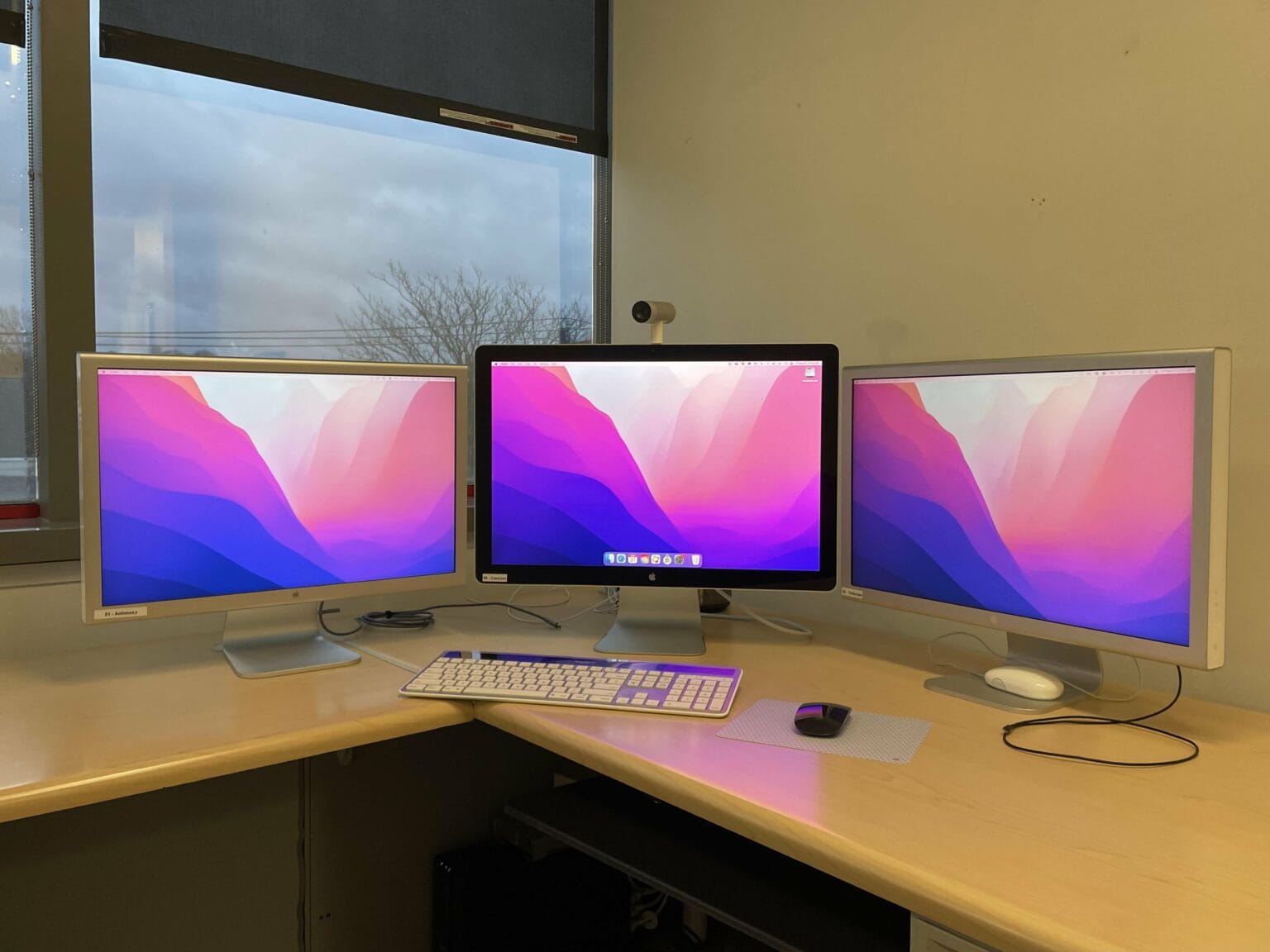 You can't see it, but a Mac Pro from 2013 drives this trio of Cinema Displays.