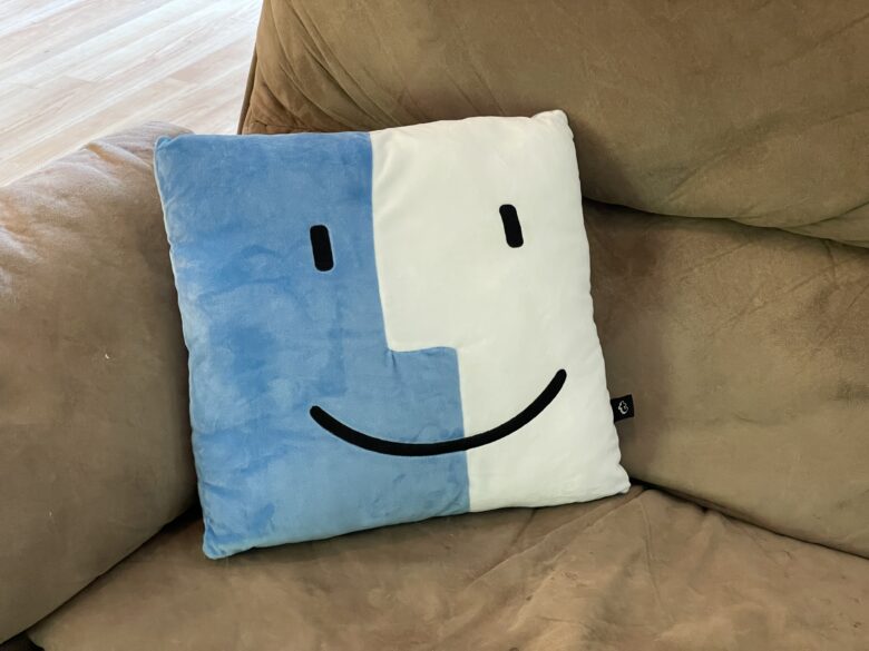 Throwboy Finder icon pillow on a dingy old sofa