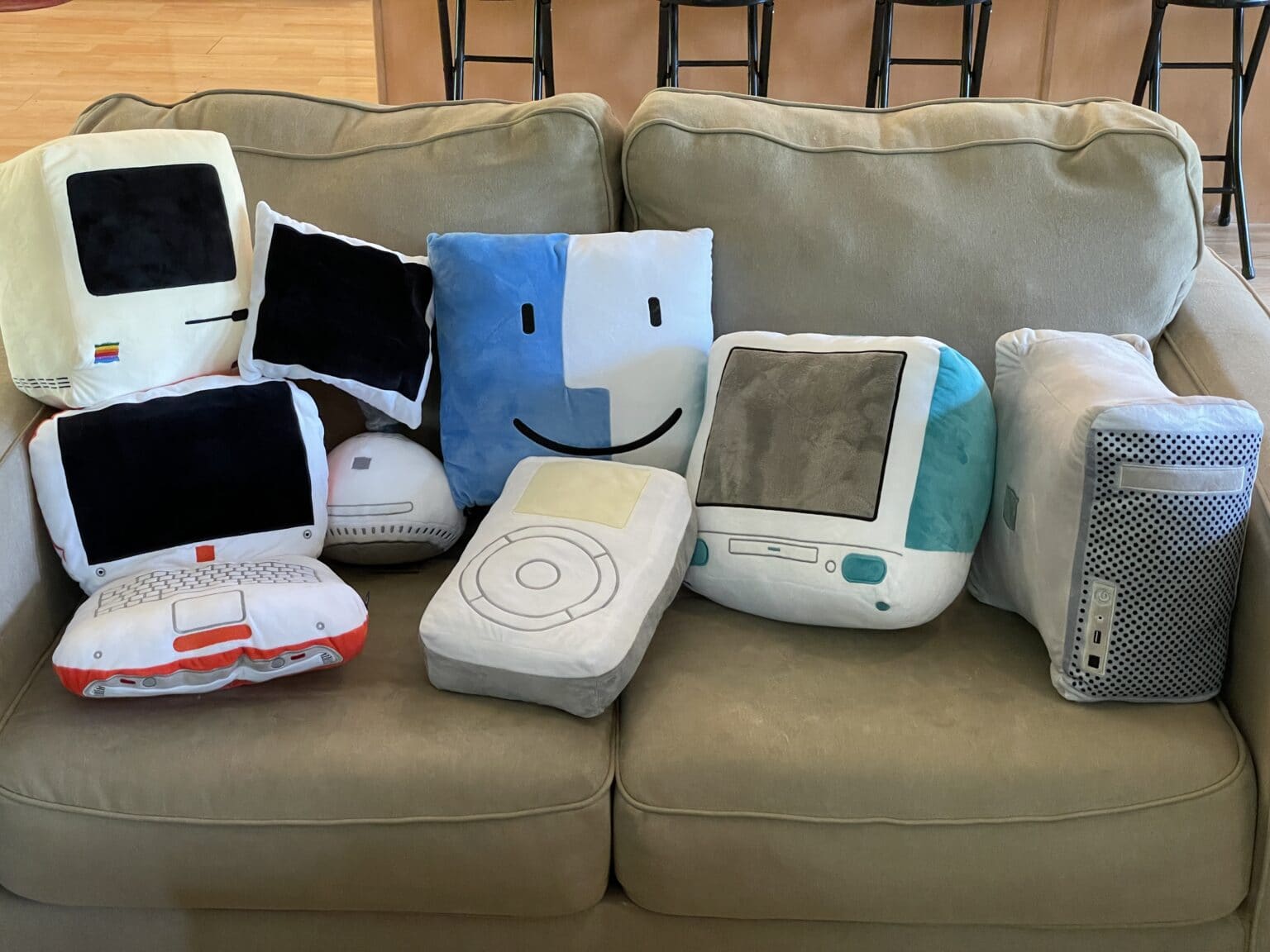 A collection of Throwboy pillows sitting on a dingy tan couch