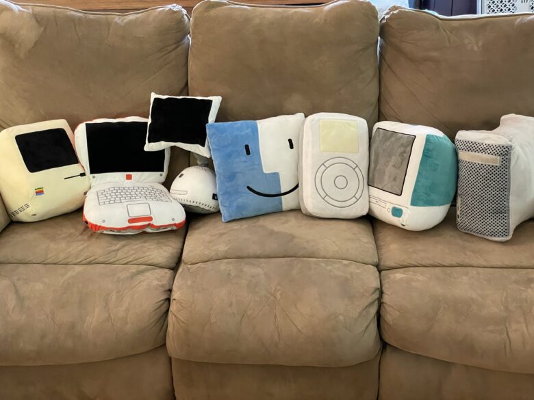 All the Throwboy pillows in a row on a dingy old couch.