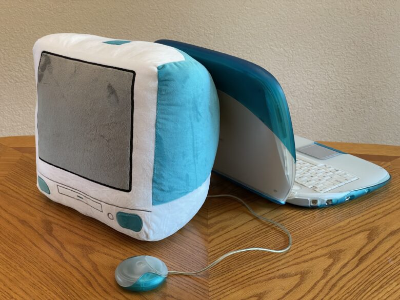 Throwboy iMac G3 with puck mouse side-by-side with an iBook G3