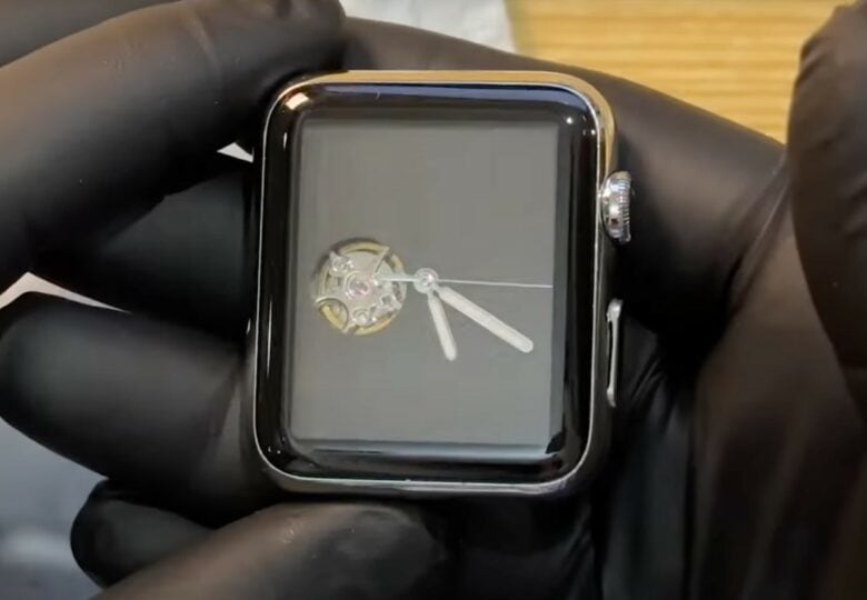 Nearly done, he shows the Face and side of the new mechanical Apple Watch, with working crown and button.