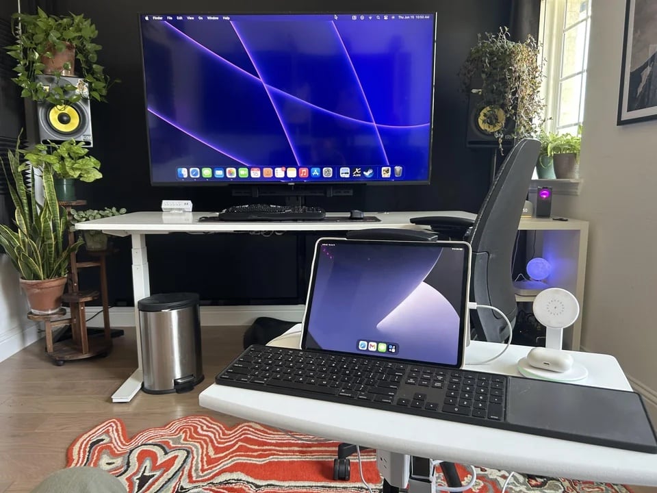 A roving laptop station holds an iPad Pro.