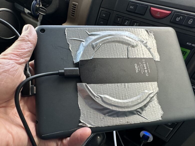 A Qi charger duct-tapped to the back of an Amazon Fire tablet
