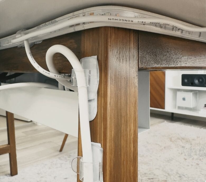 Basic Apple Guy 4 This photo shows the Phillips Hue light strip and cable running down to the cable box, along with the power cord from the surge protector running down to the outlet.