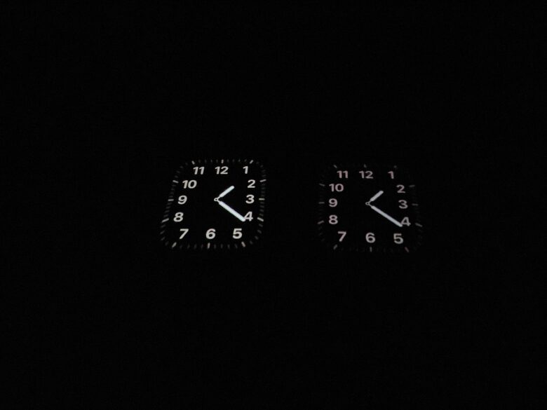 Two Apple Watches in complete darkness