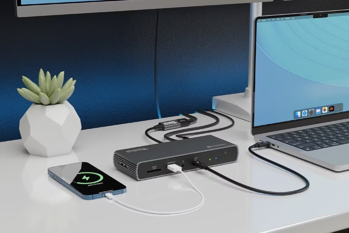 A Plugable Thunderbolt 4 dock (TBT4-UDX1) sits on a desk with multiple devices connected.
