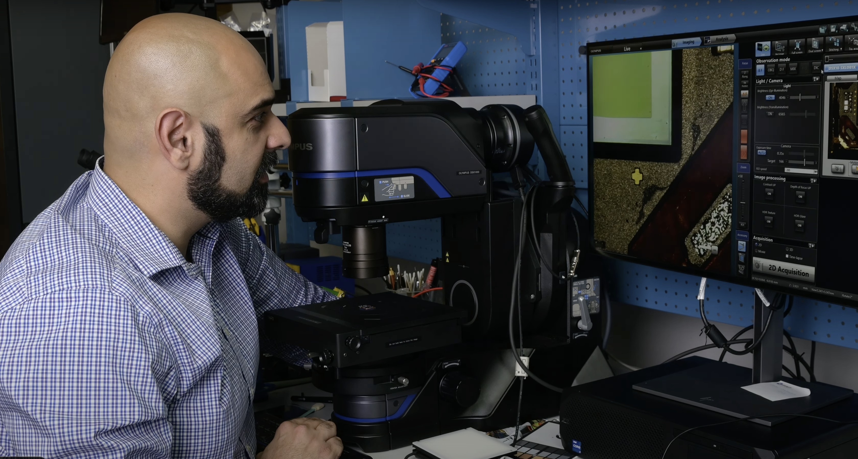 This borrowed microscope lets the video zoom in thousands of times on iPhone 15 components.