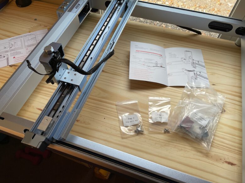 iKier engraver partially assembled with bags of parts laying around it