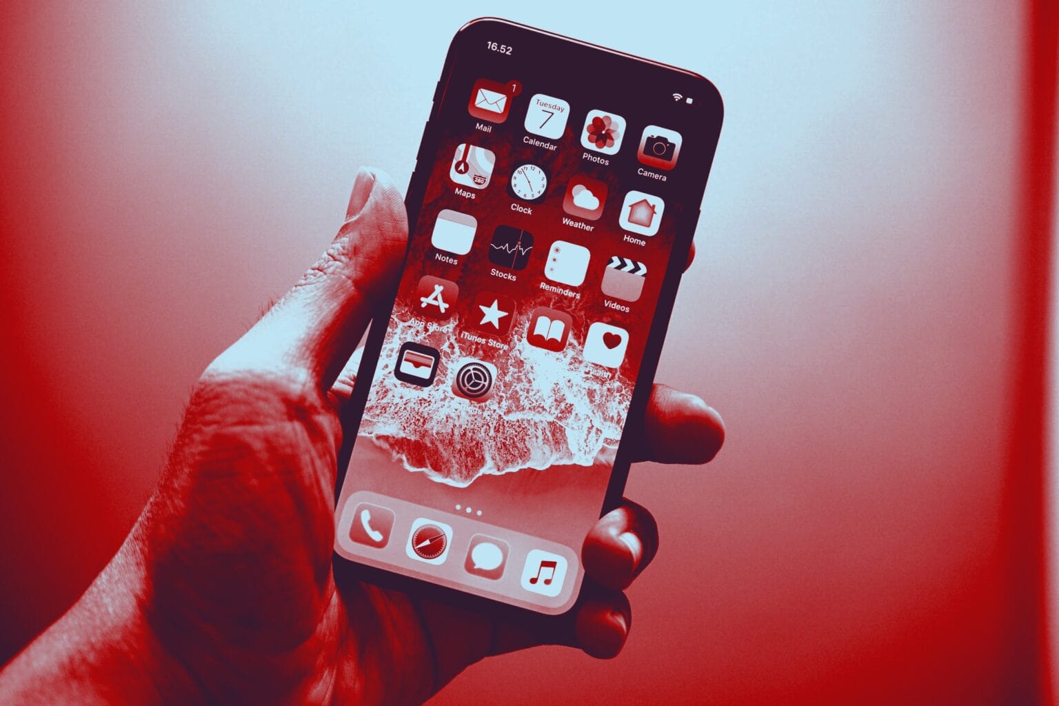 A red-tinted image of a hand holding an iPhone, meant to depict push notification spying.