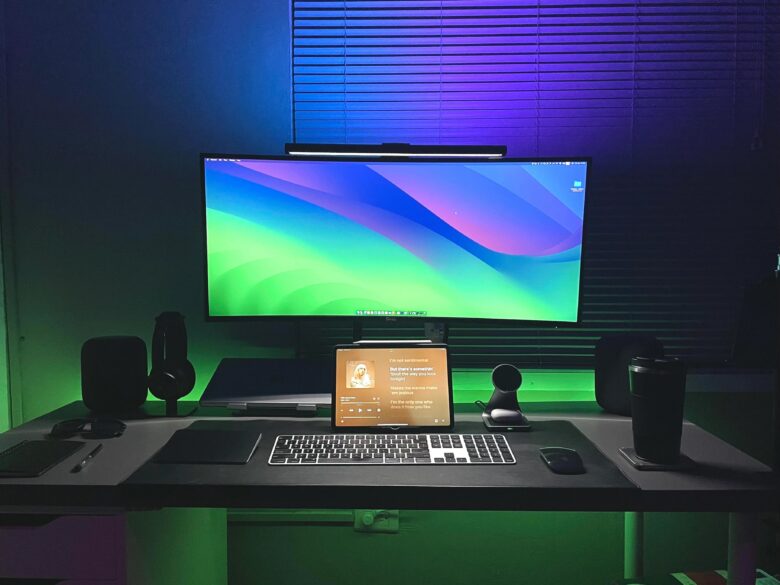 Moody lighting in MacBook Pro setup with dual HomePods