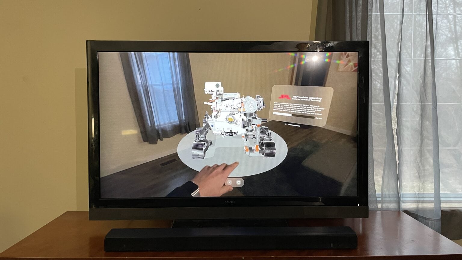 Apple TV showing a screen mirrored Vision Pro with the Explore Mars app