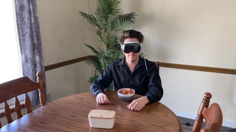 Me, wearing a Vision Pro, sitting at a kitchen table with a bowl of pasta in front of me