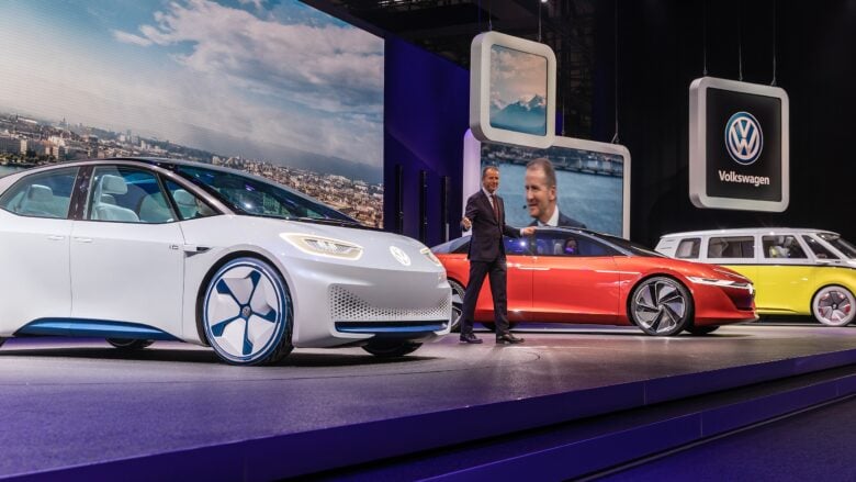 Three Volkswagen electric cars being presented on stage