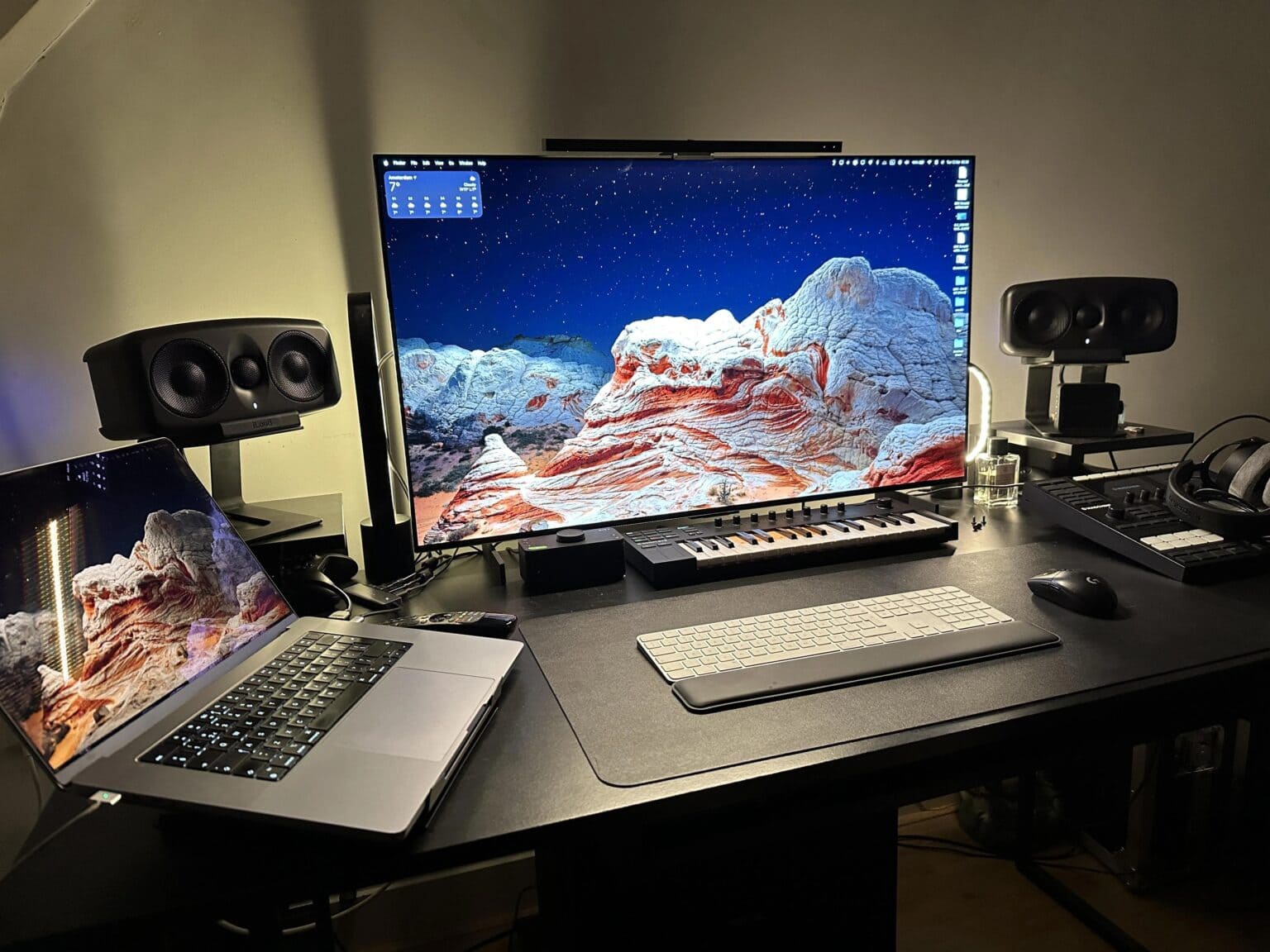 Big OLED smart TV display setup with MacBook Pro