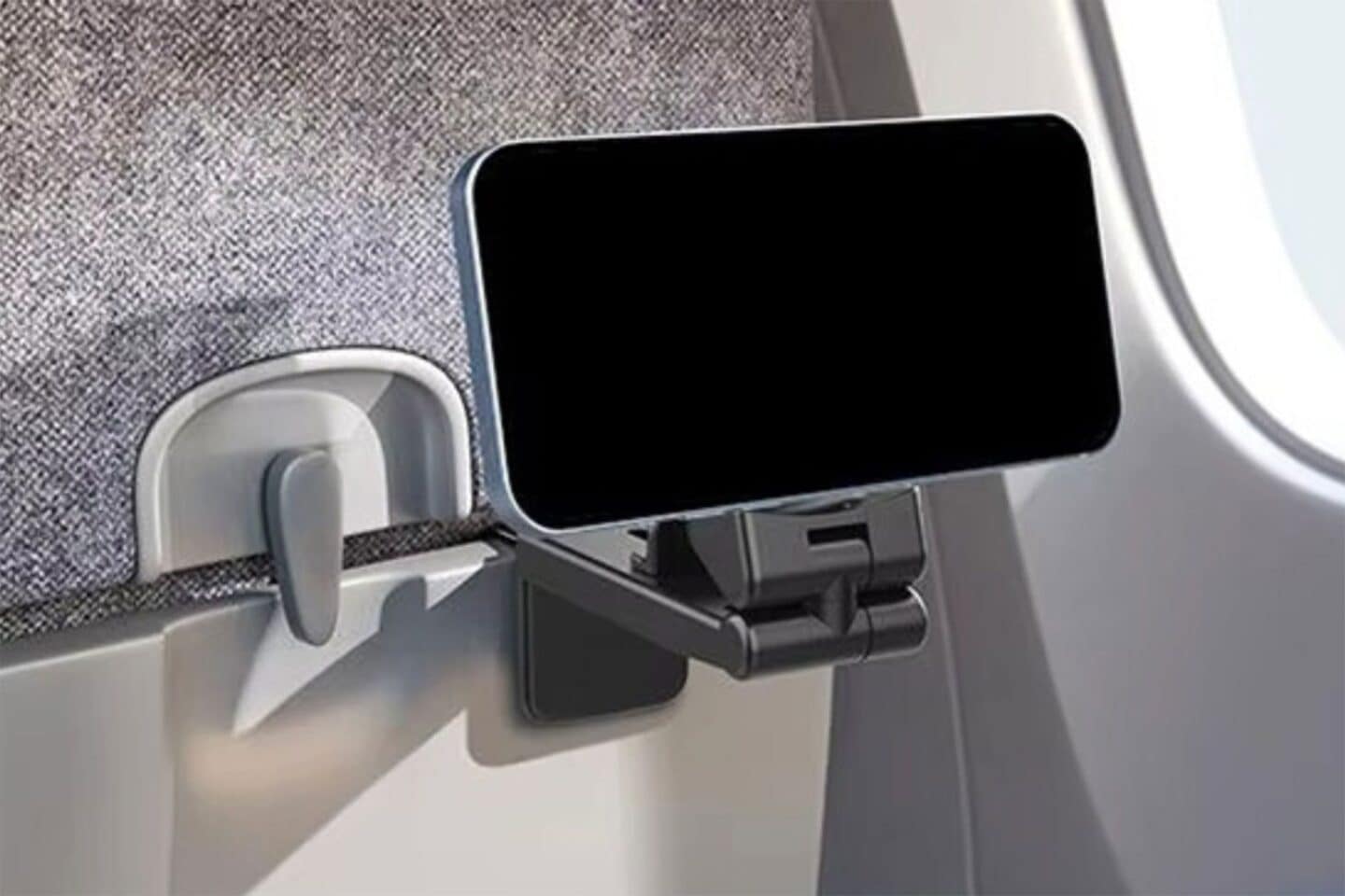 Phone attached to airplane table with an iPhone travel stand.
