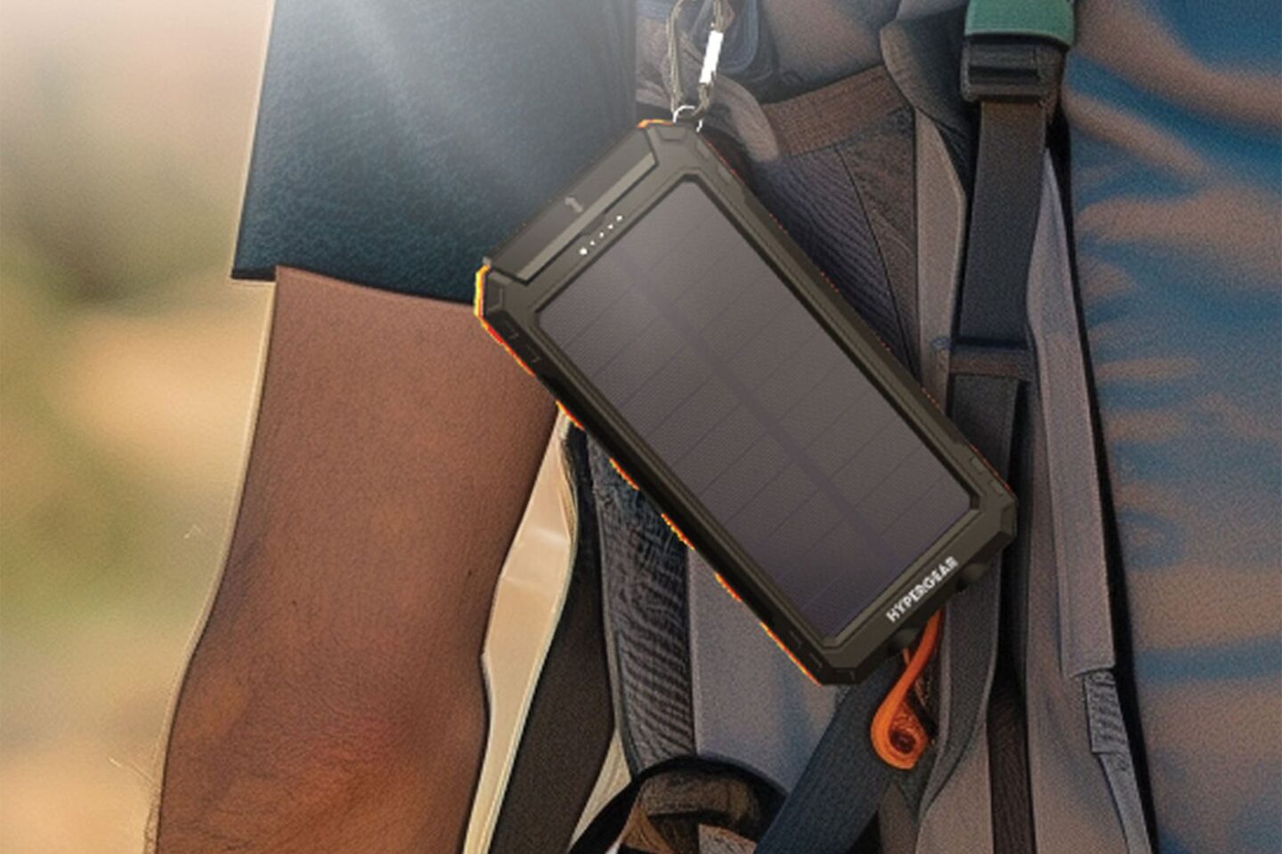 Photo of a solar power bank attached to a man's backpack.