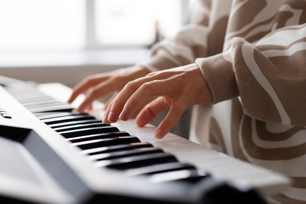 Person playing the keyboard, used to illustrate a post on the Learn to Play Piano Bundle.