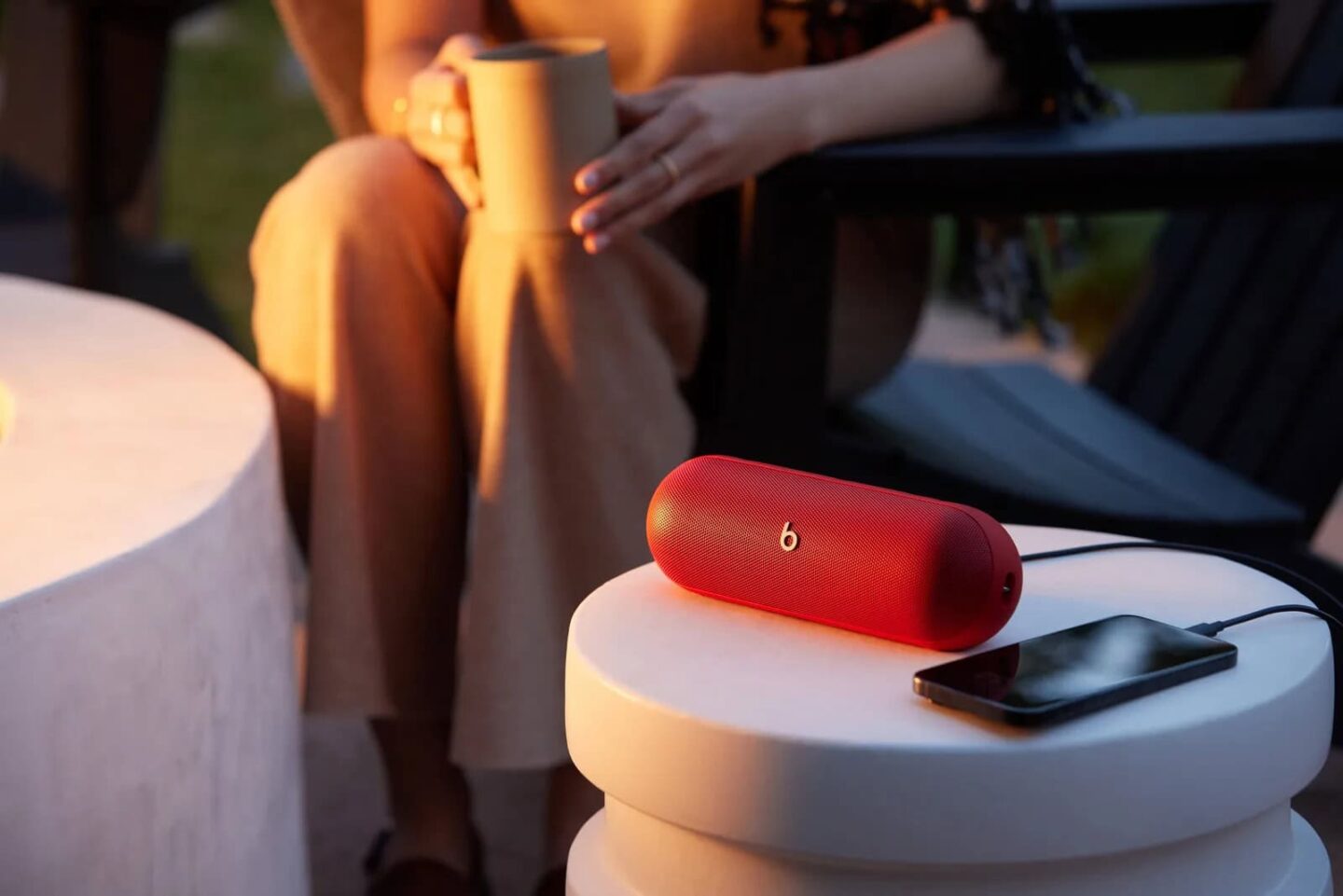 Beats Pill in red playing music from iPhone Beats Pill in red with iPhone