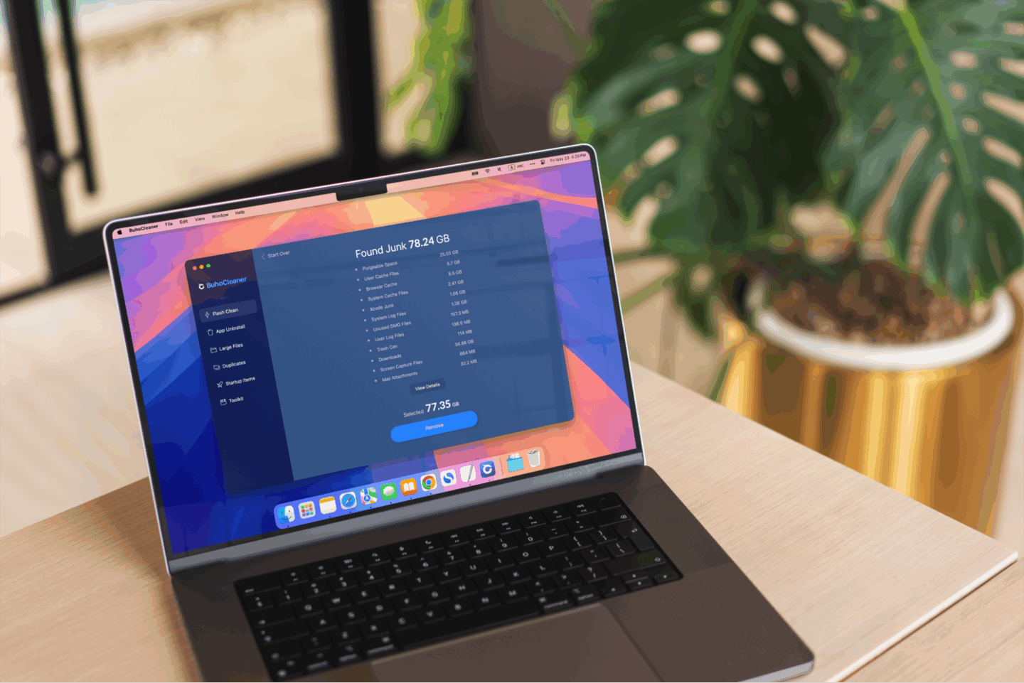 Photo of a MacBook on a table, with BuhoCleaner running on the screen