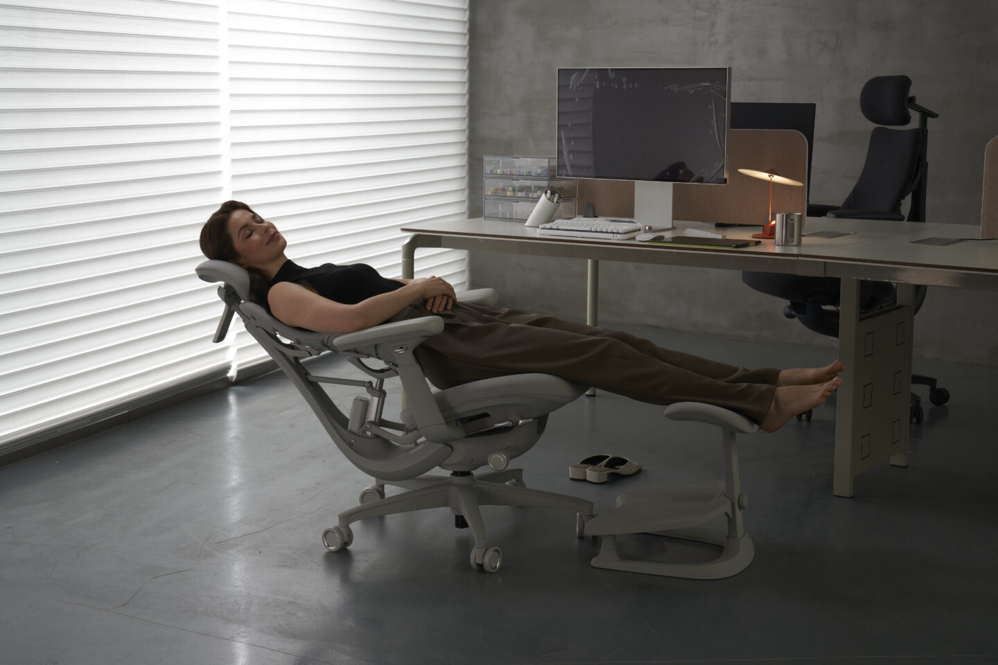 Photo of a woman reclining in a LiberNovo Omni massage office chair