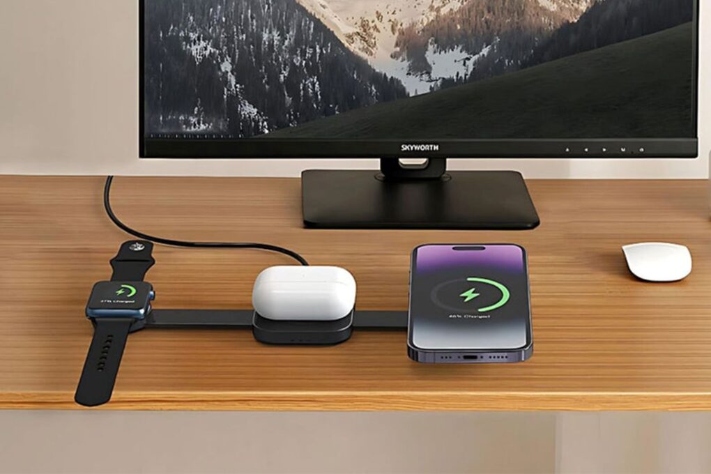 Photo shows MagFold 3-in-1 wireless charger on desk charging three Apple devices simultaneously (iPhone, Apple Watch and AirPods).