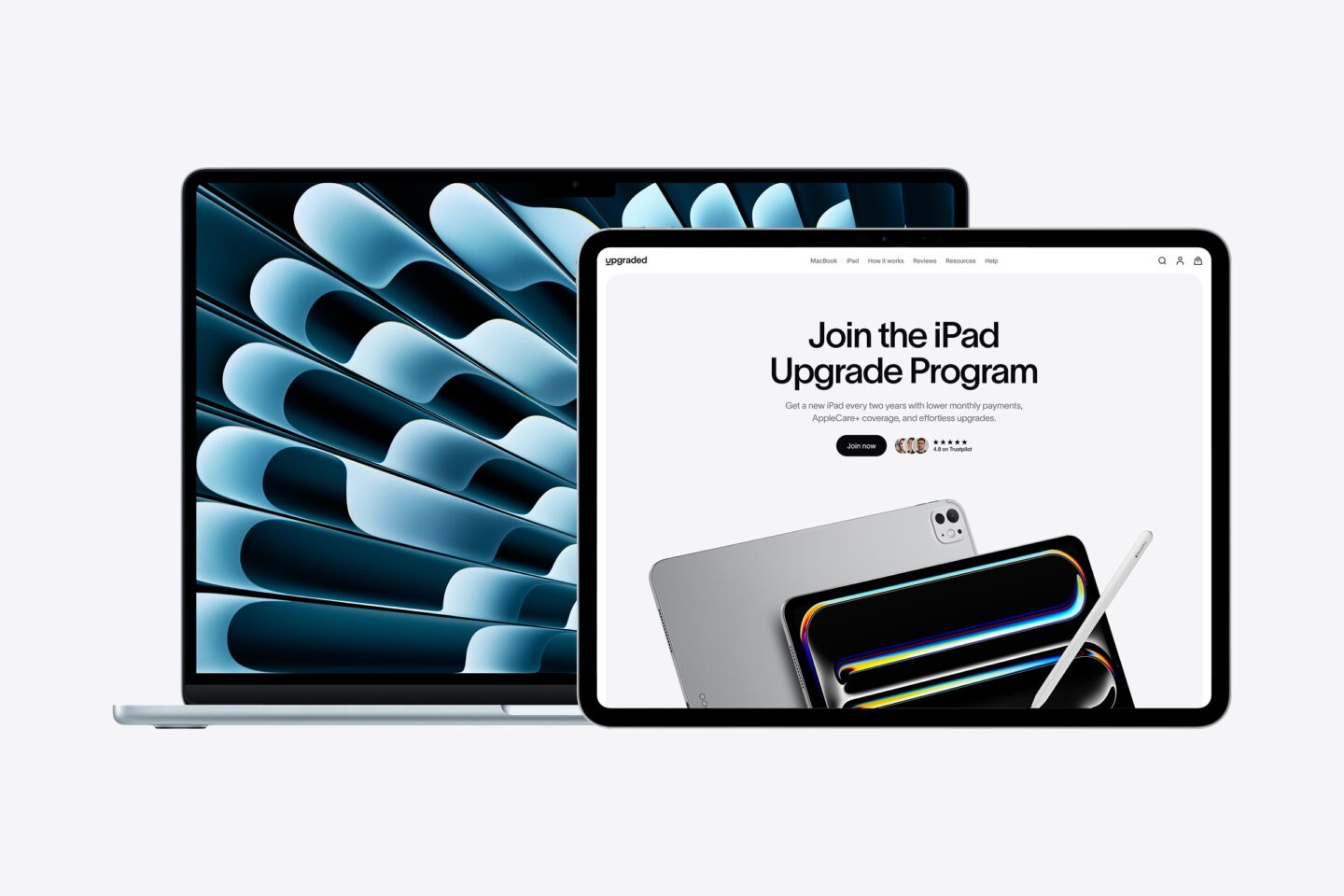 Photo of a MacBook and iPad with the Upgraded MacBook monthly payments plan, with an image on-screen that says "The MacBook Upgrade Program."