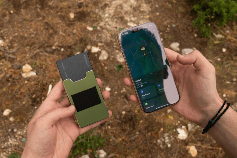 Photo of a man tracking his KeySmart SmartCard Lite using the Find My app on his iPhone while in the woods.