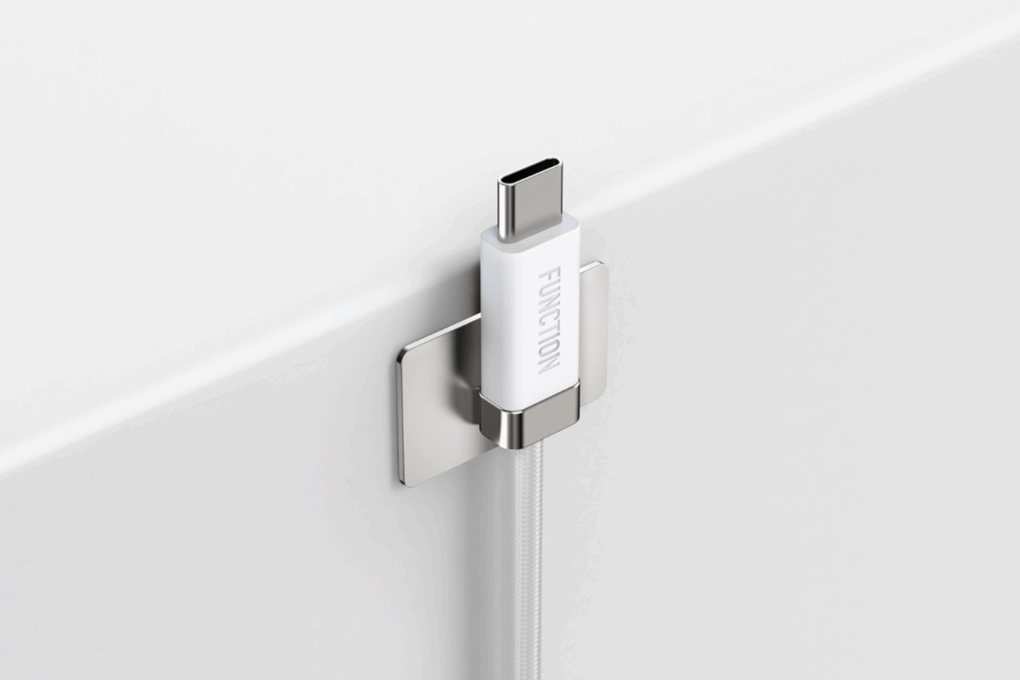 White magnetic USB-C charging cable on a mounted metal plate