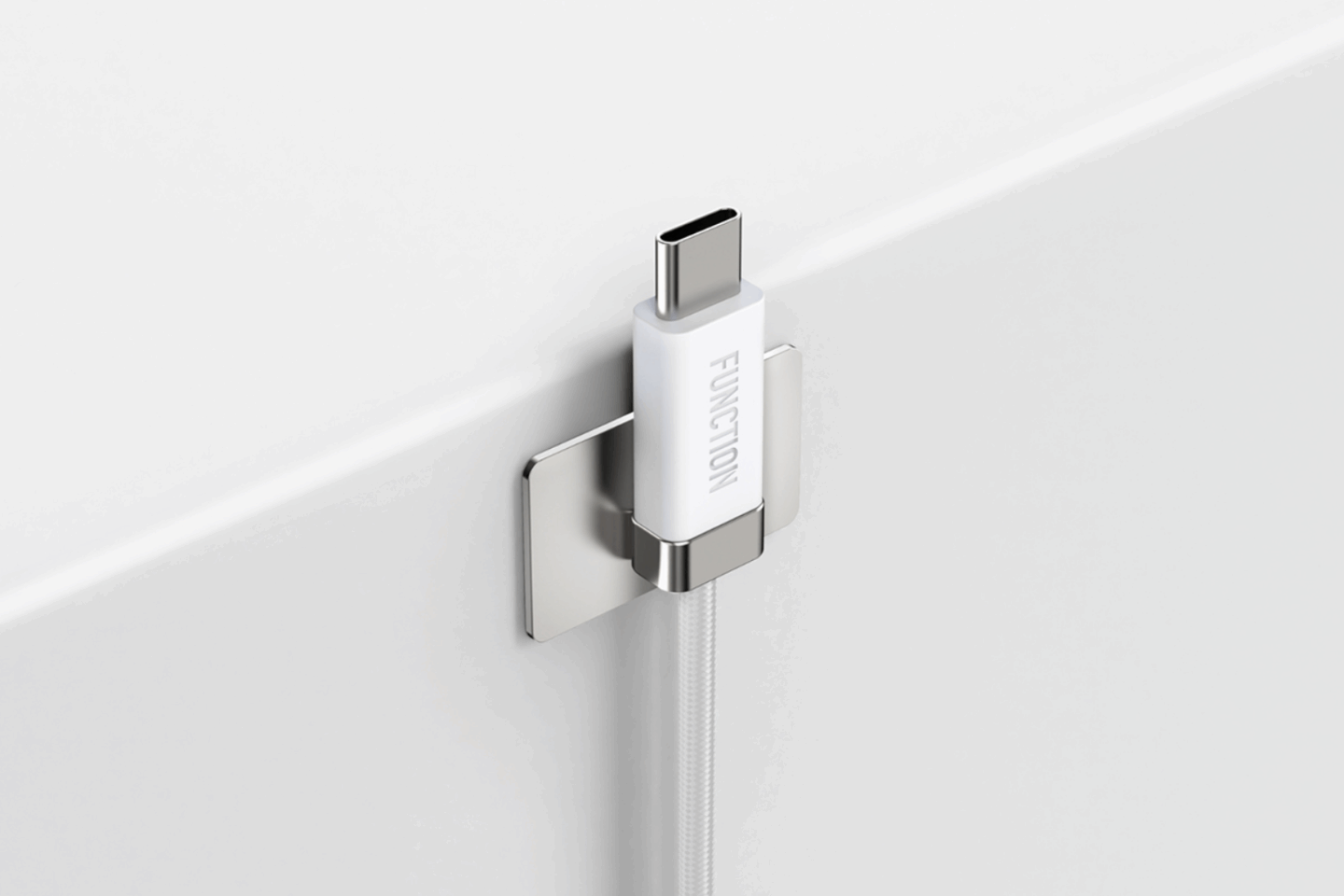 White magnetic USB-C charging cable on a mounted metal plate