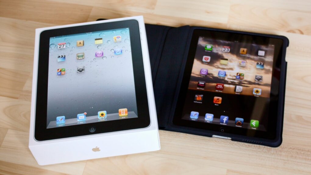 Photo of the original iPad with the box it came in, sitting on a wooden table