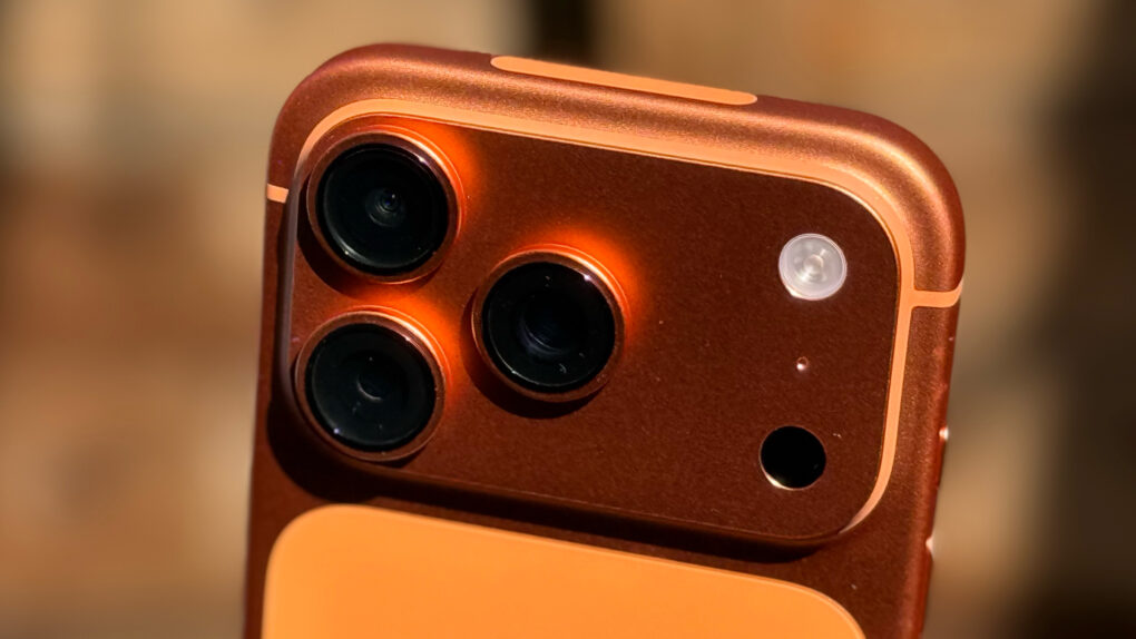 Close-up photo of the cosmic orange iPhone 17 Pro, focusing on the cameras in the