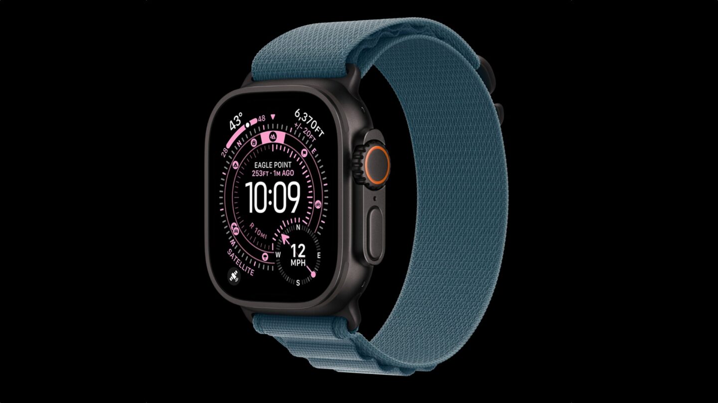 Photo of a black titanium Apple Watch Ultra 3 on a black background.