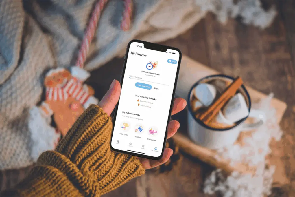 Photo of a person using the Sumizeit book summaries app on a mobile device on a cozy holiday night.