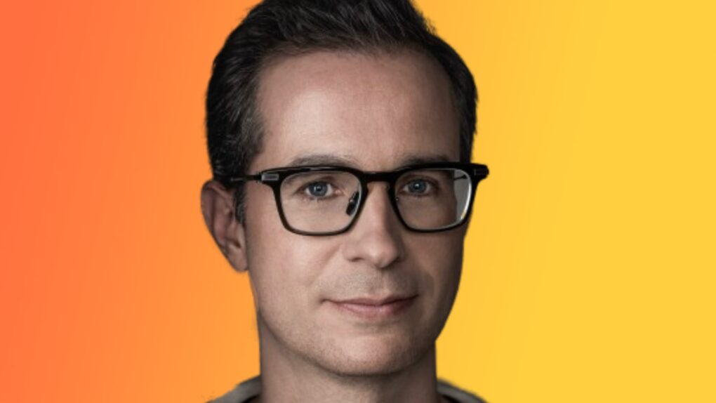 Photo of Stephen Lemay, new Apple UI designer, with background that goes from orange to yellow.