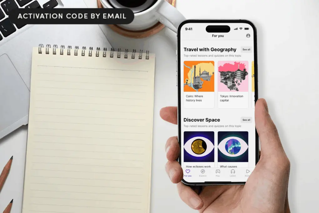 Photo of a hand holding an iPhone with the Nibble app open and a notepad on a table top.