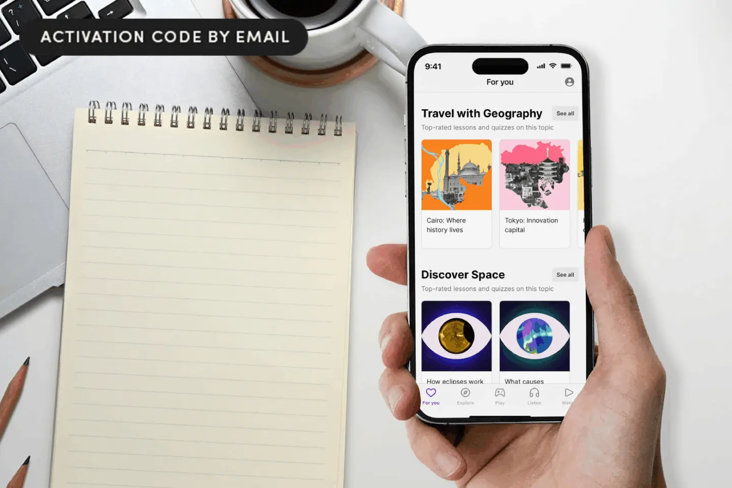 Photo of a hand holding an iPhone with the Nibble app open and a notepad on a table top.