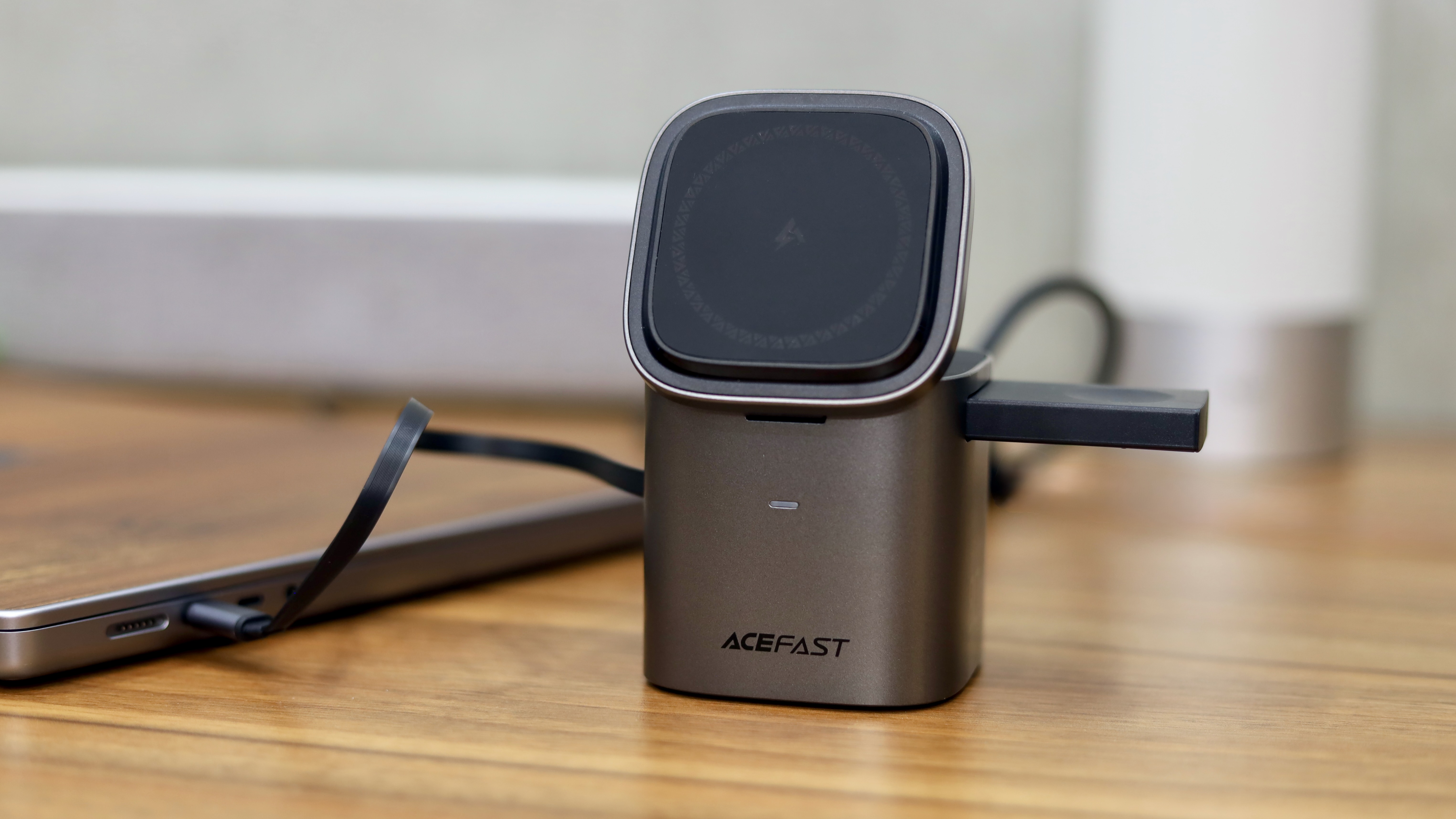 Acefast 6-in-1 charging station charging the MacBook.