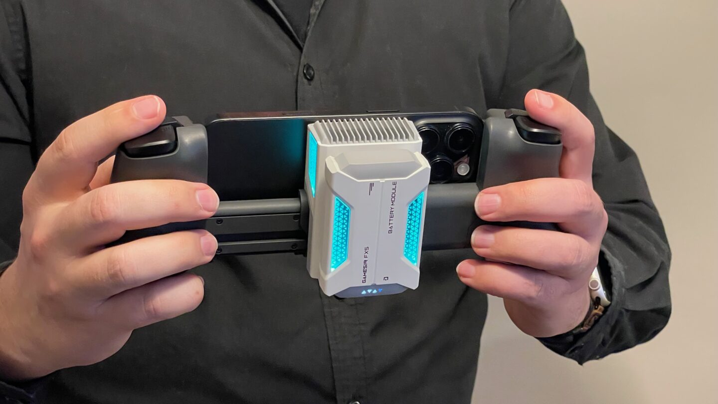 GameSir X5s with FX5 Cooler Holding an iPhone in a GameSir X5s with the FX5 cooler attached, glowing blue.