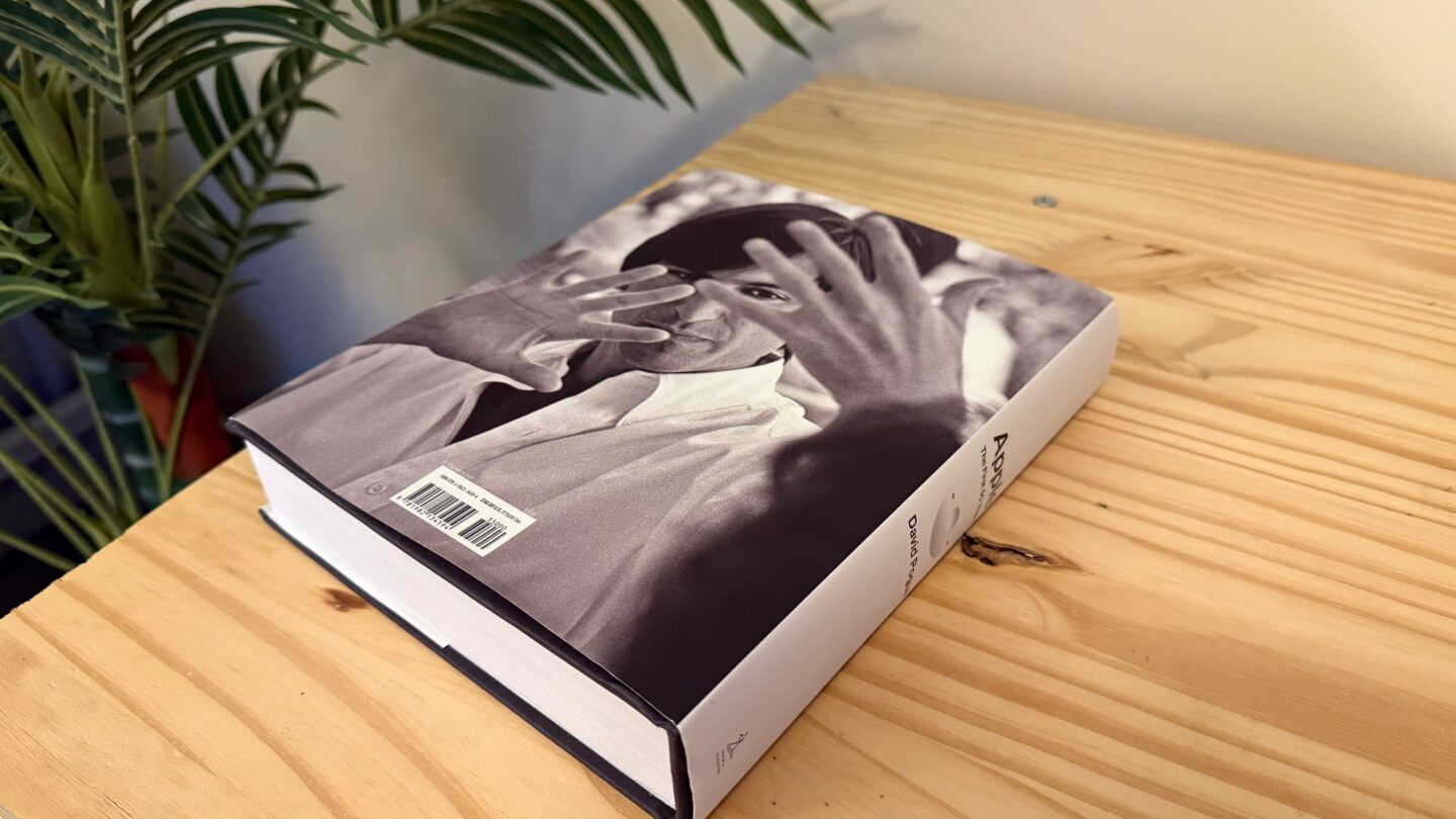 Apple First 50 Years Back 2 The back cover of Apple: The First 50 Years, a photo of Steve Jobs, sitting on a pine table with a fake tree