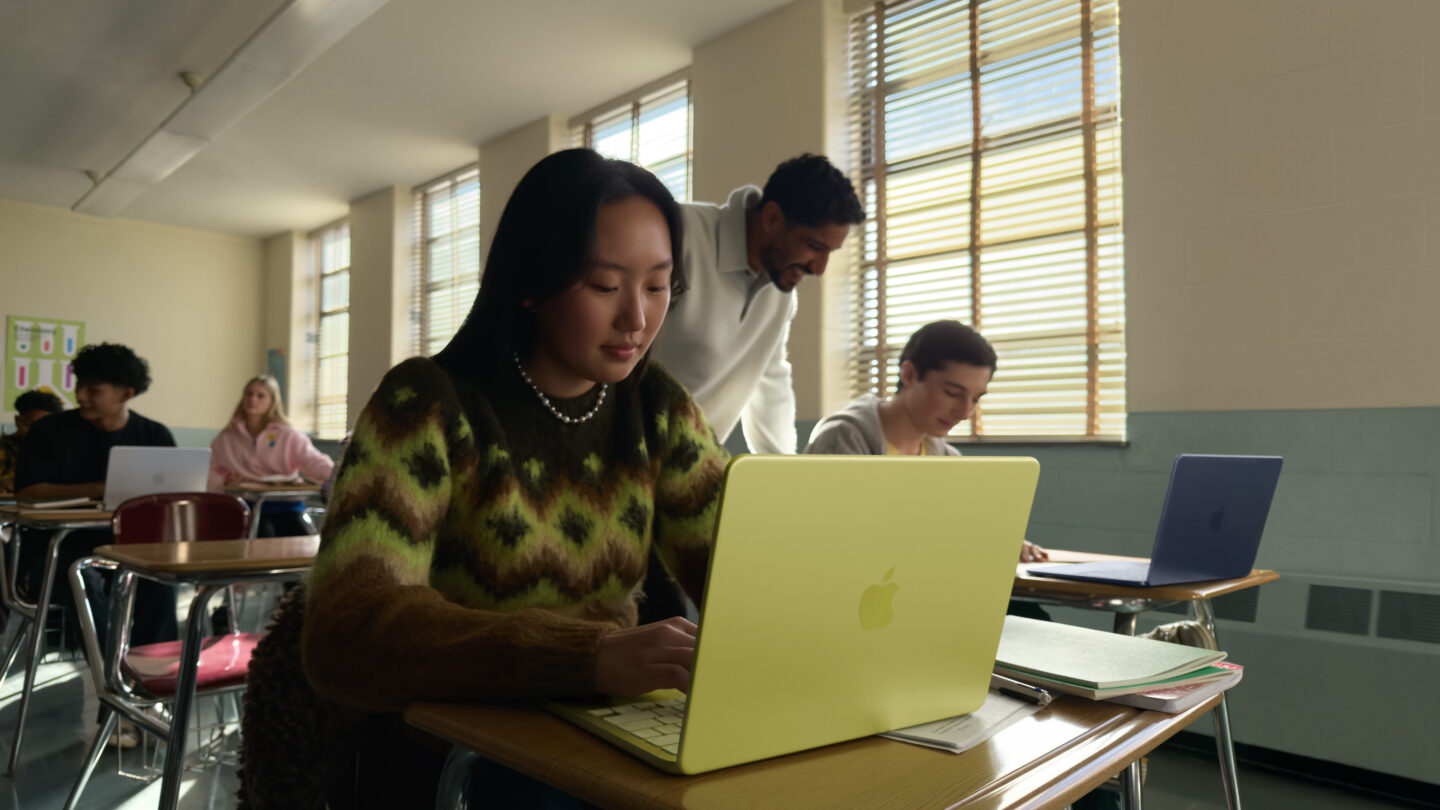 Apple MacBook Neo lifestyle 01 260304 Person using a citrus MacBook Neo in a school at a desk